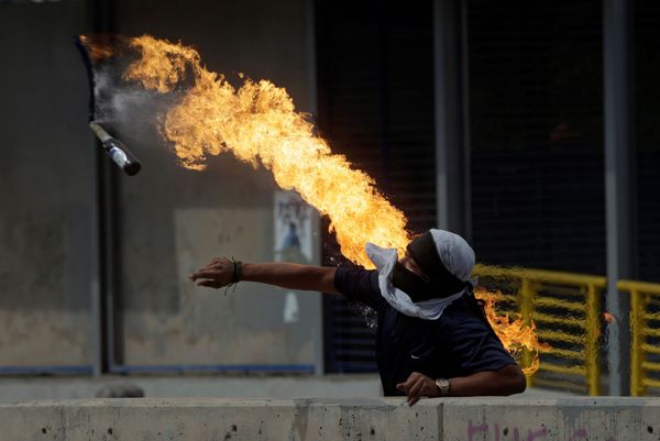 A demonstrator throws a petrol bomb at police in Honduras A demonstrator throws a petrol bomb at police in Honduras - Sputnik International