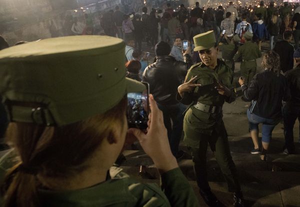 Two Cuban soldiers take a selfie during a march with torches Two Cuban soldiers take a selfie during a march with torches - Sputnik International