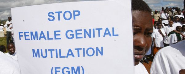 A woman in Kenya holds up a sign against FGM during a demonstration A woman in Kenya holds up a sign against FGM during a demonstration - Sputnik International