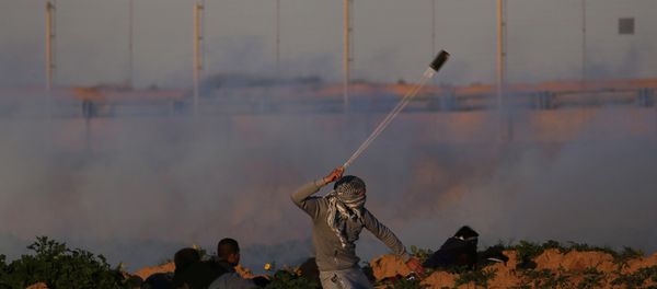 A Palestinian demonstrator hurls stones at Israeli troops during a protest at the Israel-Gaza border fence, in the southern Gaza Strip January 18, 2019 A Palestinian demonstrator hurls stones at Israeli troops during a protest at the Israel-Gaza border fence, in the southern Gaza Strip January 18, 2019 - Sputnik International