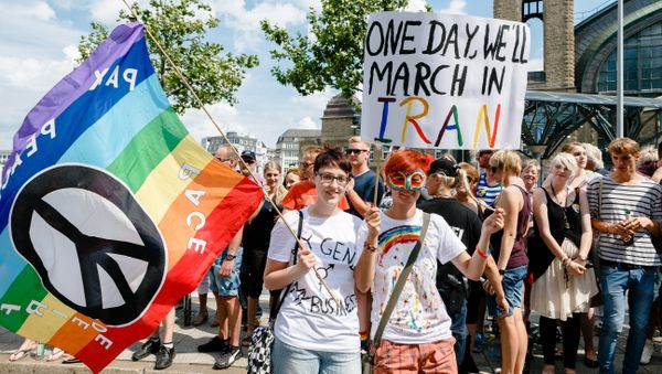 Two women hold up a sign reading One day we'll march in Iran while taking part in the Christopher Street Parade in Hamburg, northern Germany, on August 2, 2014 - Sputnik International