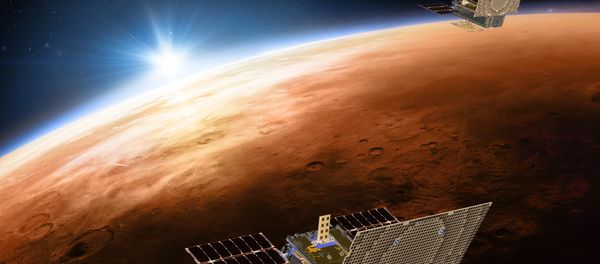 This illustration made available by NASA on March 29, 2018 shows the twin Mars Cube One (MarCO) spacecraft flying over Mars with Earth and the sun in the distance - Sputnik International