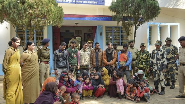 Indian police officials stand next to Rohingya Muslims after they were arrested in two northeastern states, outside a police station in Agartala, India, Tuesday, Jan. 22, 2019 Indian police officials stand next to Rohingya Muslims after they were arrested in two northeastern states, outside a police station in Agartala, India, Tuesday, Jan. 22, 2019 - Sputnik International