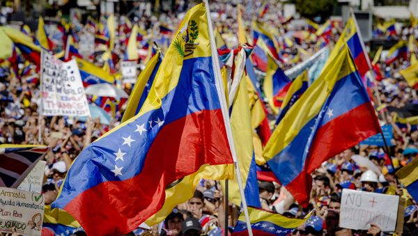 Supporters of Juan Guaido, self-proclaimed Interim President of Venezuela, wave flag during a rally, in Caracas, Venezuela - Sputnik International