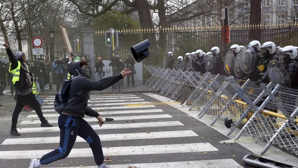A protestor throws an object at a police line during a demonstration in Brussels, Saturday, Dec. 8, 2018. - Sputnik International