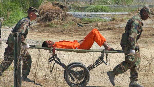 a detainee from Afghanistan is carried on a stretcher before being interrogated by military officials at the detention facility Camp X-Ray on Guantanamo Bay U.S. Naval Base in Cuba - Sputnik International