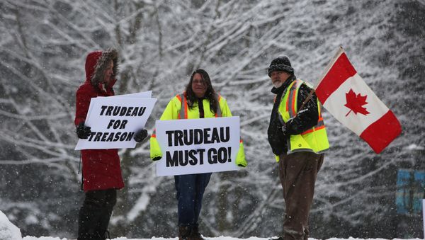 Protesters hold signs as Canada's Prime Minister Justin Trudeau campaigns with Liberal candidate for Burnaby South riding Richard T. Lee in Burnaby, B.C., Canada, 10 February , 2019 - Sputnik International
