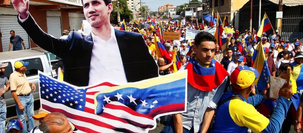 Opposition supporters carrying a cardboard cut-out of Venezuelan opposition leader Juan Guaido take part in a rally against Venezuelan President Nicolas Maduro's government and to commemorate the Day of the Youth in Maracaibo, Venezuela February 12, 2019. - Sputnik International