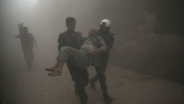 Civil defense members carry an injured man after an air strike in the rebel-held Douma neighbourhood of Damascus, Syria October 12, 2016. - Sputnik International