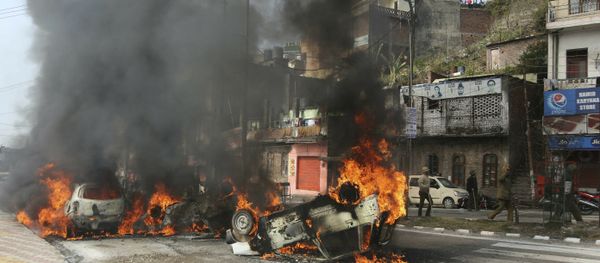 Vehicles stand in flames after it was set on fire by a mob during a protest against Thursday's attack on a paramilitary convoy, in Jammu, India, Friday, Feb.15, 2019 - Sputnik International
