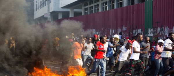 Demonstrators run away during a protest to demand the resignation of President Jovenel Moise and demanding to know how Petro Caribe funds have been used by the current and past administrations, in Port-au-Prince, Haiti, Saturday, Feb. 9, 2019. Much of the financial support to help Haiti rebuild after the 2010 earthquake comes from Venezuela's Petro Caribe fund, a 2005 pact that gives suppliers below-market financing for oil and is under the control of the central government.  - Sputnik International
