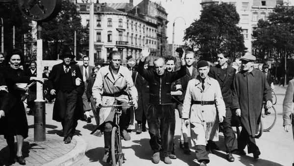A Belgian collaborator is hustled through the streets of Liege to jail, on Sept. 13, 1944, to save him from being lynched. - Sputnik International