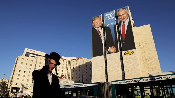 A man walks past a Likud election campaign billboard, depicting U.S. President Donald Trump shaking hands with Israeli Prime Minister Benjamin Netanyahu, in Jerusalem February 4, 2019 A man walks past a Likud election campaign billboard, depicting U.S. President Donald Trump shaking hands with Israeli Prime Minister Benjamin Netanyahu, in Jerusalem February 4, 2019 - Sputnik International