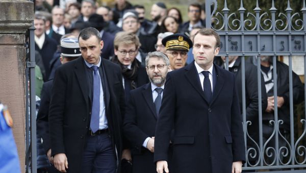 French President Emmanuel Macron, right, with France's Chief Rabbi Haim Korsia, center, leave the Jewish cemetery where tombs were tagged with swastikas in Quatzenheim, eastern France, Tuesday, Feb.19, 2019. - Sputnik International