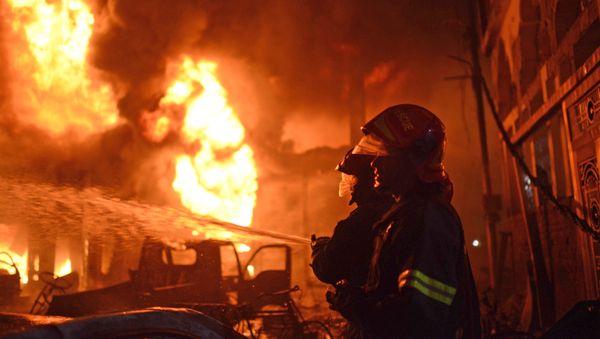 In this Wednesday, Feb. 20, 2019, photo, firefighters try to douse a fire in Dhaka, Bangladesh. - Sputnik International
