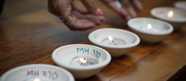 Relative of passengers on board the missing Malaysia Airlines Flight MH370 light up candle during the Day of Remembrance for MH370 event Relative of passengers on board the missing Malaysia Airlines Flight MH370 light up candle during the Day of Remembrance for MH370 event - Sputnik International