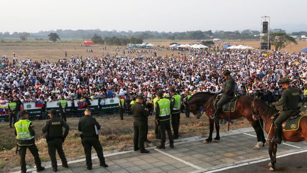 Police officers stand guard as people attend the Venezuela Aid Live concert near the Tienditas cross-border bridge between Colombia and Venezuela, in Cucuta, Colombia, February 22, 2019. Police officers stand guard as people attend the Venezuela Aid Live concert near the Tienditas cross-border bridge between Colombia and Venezuela, in Cucuta, Colombia, February 22, 2019. - Sputnik International