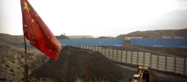 In this Wednesday, Nov. 4, 2015 photo, a Chinese flag moves in the breeze as a loader moves coal at a coal mine near Ordos in northern China's Inner Mongolia Autonomous Region. In this Wednesday, Nov. 4, 2015 photo, a Chinese flag moves in the breeze as a loader moves coal at a coal mine near Ordos in northern China's Inner Mongolia Autonomous Region. - Sputnik International