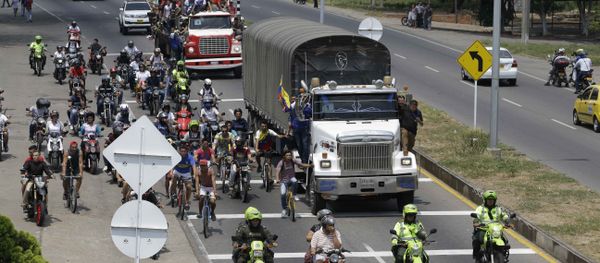 People ride atop and alongside semi-trailers accompanying U.S. humanitarian aid destined for Venezuela, in Cucuta, Colombia, Saturday, Feb. 23, 2019 . People ride atop and alongside semi-trailers accompanying U.S. humanitarian aid destined for Venezuela, in Cucuta, Colombia, Saturday, Feb. 23, 2019 . - Sputnik International