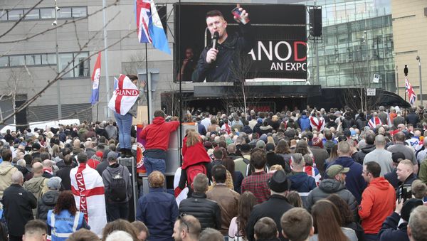 Former leader and founder of the English Defence League, Tommy Robinson seen on screen, as he addresses an EDL protest over a TV program, outside the BBC building in Salford, England, Saturday Feb. 23, 2019. - Sputnik International