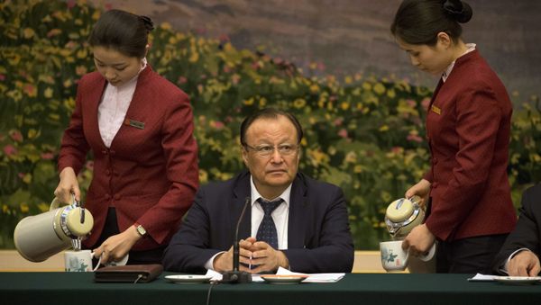 Shohrat Zakir, chairman of the Xinjiang Uyghur Autonomous Region, prepares to describe the mass internment of ethnic minority Muslims in the country’s far west as a system of training centers that saves Muslims from religious extremism by teaching them to speak Mandarin and accept modern science - Sputnik International