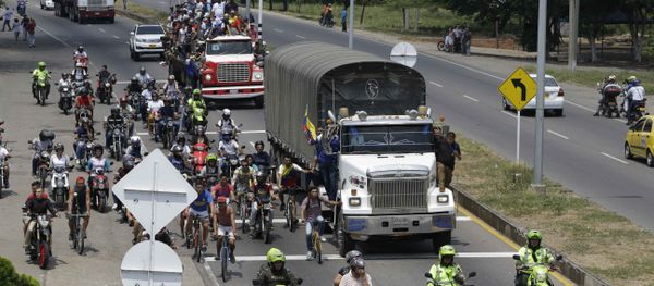 Venezuelans ride atop and alongside semi-trailers accompanying U.S. humanitarian aid destined for Venezuela, in Cucuta, Colombia, Saturday, Feb. 23, 2019 Venezuelans ride atop and alongside semi-trailers accompanying U.S. humanitarian aid destined for Venezuela, in Cucuta, Colombia, Saturday, Feb. 23, 2019 - Sputnik International