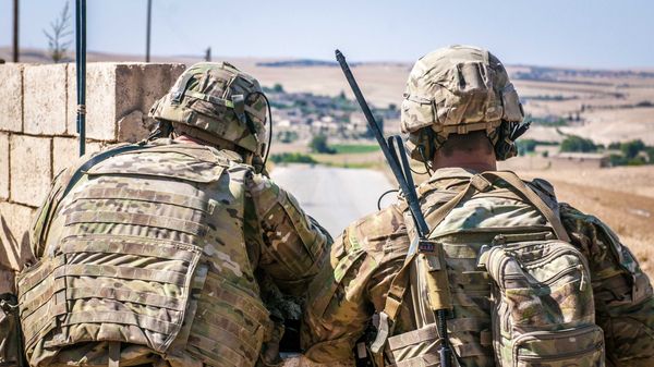 Two U.S. Soldiers keep an eye on the demarcation line during a security patrol outside Manbij, Syria, June 26, 2018 - Sputnik International
