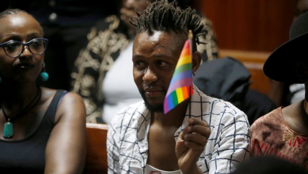 An LGBT activist holds the rainbow flag during a court hearing in the Milimani high Court in Nairobi in Nairobi, Kenya - Sputnik International