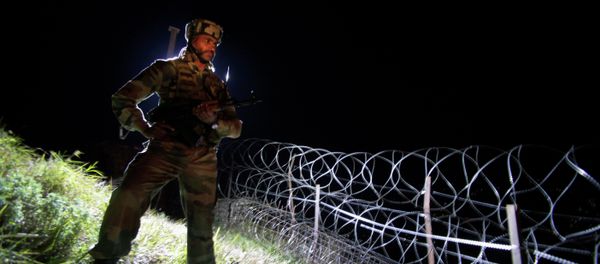 In this Dec. 22, 2013 photo, an Indian army soldier stands guard along barbed wire near the Line of Control (LOC), that divides Kashmir between India and Pakistan, at Krishna Ghati (KG Sector) in Poonch, 290 kilometers (180 miles) from Jammu, India In this Dec. 22, 2013 photo, an Indian army soldier stands guard along barbed wire near the Line of Control (LOC), that divides Kashmir between India and Pakistan, at Krishna Ghati (KG Sector) in Poonch, 290 kilometers (180 miles) from Jammu, India - Sputnik International