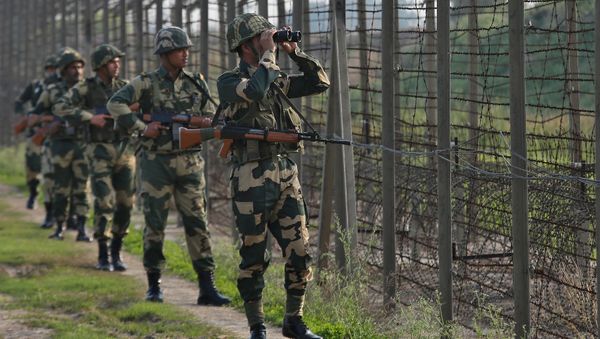 India's Border Security Force (BSF) soldiers patrol along the fenced border with Pakistan in Ranbir Singh Pura sector near Jammu February 26, 2019 - Sputnik International