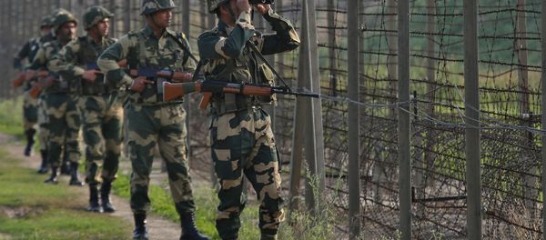 India's Border Security Force (BSF) soldiers patrol along the fenced border with Pakistan in Ranbir Singh Pura sector near Jammu February 26, 2019 - Sputnik International