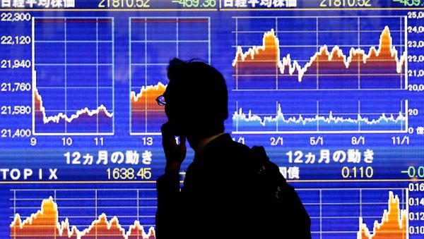 A man looks at an electronic stock quotation board showing Japan's Nikkei average outside a brokerage in Tokyo, Japan, November 13, 2018 A man looks at an electronic stock quotation board showing Japan's Nikkei average outside a brokerage in Tokyo, Japan, November 13, 2018 - Sputnik International