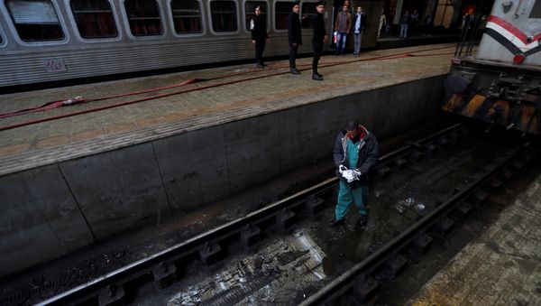 A rescue worker inspects the damage after a fire caused deaths and injuries at the main train station, in Cairo, Egypt, February 27, 2019. - Sputnik International