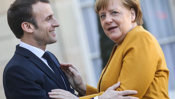 French President Emmanuel Macron (L) welcomes German Chancellor Angela Merkel as she arrives for a working meeting at the Elysee Palace on febuary 27, 2019, in Paris - Sputnik International