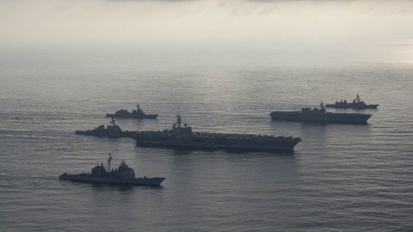 The aircraft carrier USS Ronald Reagan (CVN 76), second from bottom, lead ship of the Ronald Reagan Carrier Strike Group, the guided-missile cruiser USS Antietam (CG 54), bottom, and the guided-missile destroyer USS Milius (DDG 69), left, conduct a photo exercise with the Japan Maritime Self-Defense Force (JMSDF) helicopter destroyer JS Kaga (DDH 184), second from top, and the JMSDF destroyers JS Inazuma (DD 105) and JS Suzutsuki (DD 117). The Ronald Reagan Carrier Strike Group is forward-deployed to the U.S. 7th Fleet area of operations in support of security and stability in the Indo-Pacific region. - Sputnik International