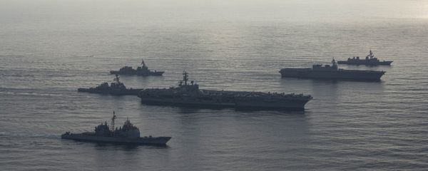 The aircraft carrier USS Ronald Reagan (CVN 76), second from bottom, lead ship of the Ronald Reagan Carrier Strike Group, the guided-missile cruiser USS Antietam (CG 54), bottom, and the guided-missile destroyer USS Milius (DDG 69), left, conduct a photo exercise with the Japan Maritime Self-Defense Force (JMSDF) helicopter destroyer JS Kaga (DDH 184), second from top, and the JMSDF destroyers JS Inazuma (DD 105) and JS Suzutsuki (DD 117). The Ronald Reagan Carrier Strike Group is forward-deployed to the U.S. 7th Fleet area of operations in support of security and stability in the Indo-Pacific region. - Sputnik International