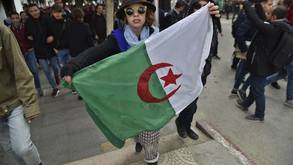 A woman holds an Algerian flag during demonstrations against President Bouteflika in Algiers on 26 February A woman holds an Algerian flag during demonstrations against President Bouteflika in Algiers on 26 February - Sputnik International