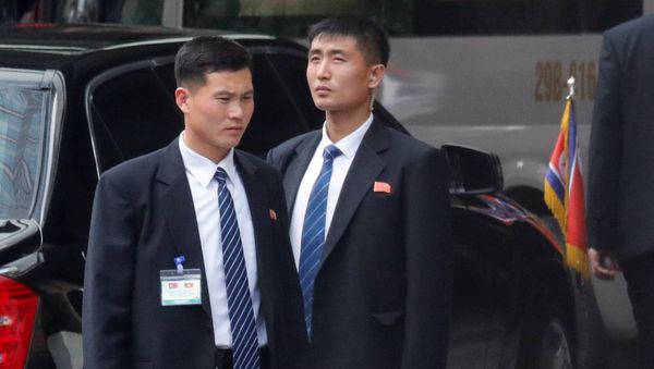 Members of North Korea's leader Kim Jong Un's security stand guard as he leaves the Melia hotel in Hanoi, Vietnam, March 1, 2019 - Sputnik International