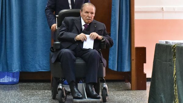 (FILES) In this file photo taken on May 04, 2017 Algerian President Abdelaziz Bouteflika is seen on a wheelchair as he votes at a polling station in Algiers. - Sputnik International