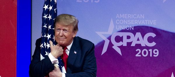 President Donald Trump hugs the American flag as he arrives to speak at Conservative Political Action Conference, CPAC 2019, in Oxon Hill, Md., Saturday, March 2, 2019. - Sputnik International