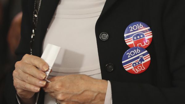 A woman wears badges for Democratic Party and Republican Party on her jacket during a live broadcasting of the 2016 U.S. Presidential Election results - Sputnik International