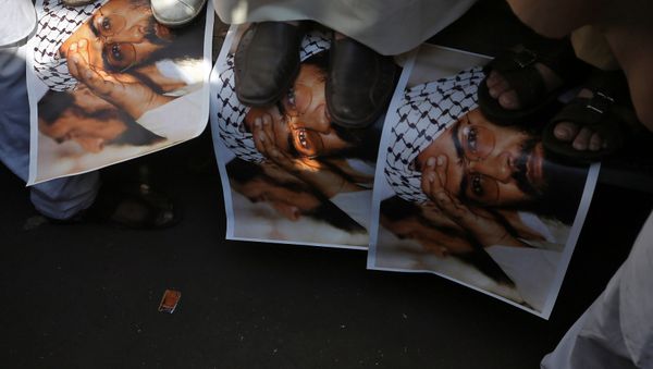 Demonstrators step on the posters of Maulana Masood Azhar, head of Pakistan-based militant group Jaish-e-Mohammad which claimed attack on a bus that killed 44 Central Reserve Police Force (CRPF) personnel in south Kashmir on Thursday, during a protest in Mumbai, India, February 15, 2019 Demonstrators step on the posters of Maulana Masood Azhar, head of Pakistan-based militant group Jaish-e-Mohammad which claimed attack on a bus that killed 44 Central Reserve Police Force (CRPF) personnel in south Kashmir on Thursday, during a protest in Mumbai, India, February 15, 2019 - Sputnik International