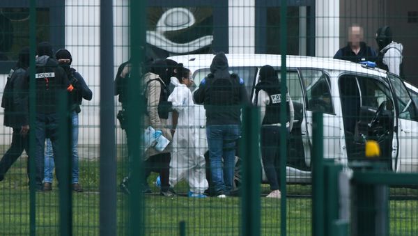 Michaël Chiolo, wearing a white forensic jumpsuit, is escorted into custody after the incident at Condon-sur-Sarthe prison - Sputnik International