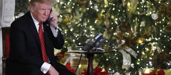 President Donald Trump listens on the phone as he shares updates to track Santa's movements from the North American Aerospace Defense Command (NORAD) Santa Tracker on Christmas Eve, Monday, Dec. 24, 2018 President Donald Trump listens on the phone as he shares updates to track Santa's movements from the North American Aerospace Defense Command (NORAD) Santa Tracker on Christmas Eve, Monday, Dec. 24, 2018 - Sputnik International
