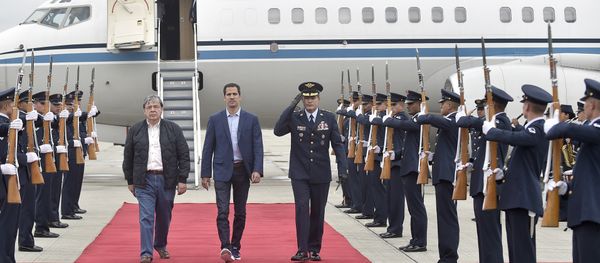 In this photo released by Colombia's presidential press office, Venezuelan opposition leader Juan Guaido, who declared himself interim president of Venezuela, is escorted by Air Force Gen. Luis Carlos Cordoba, right, and Colombian Foreign Minister Carlos Holmes Trujillo during a welcome ceremony for him at the military airport in Bogota, Colombia, Sunday, Feb. 24, 2019 In this photo released by Colombia's presidential press office, Venezuelan opposition leader Juan Guaido, who declared himself interim president of Venezuela, is escorted by Air Force Gen. Luis Carlos Cordoba, right, and Colombian Foreign Minister Carlos Holmes Trujillo during a welcome ceremony for him at the military airport in Bogota, Colombia, Sunday, Feb. 24, 2019 - Sputnik International