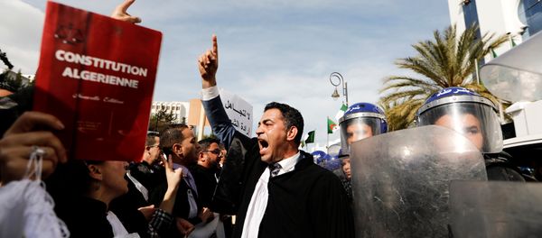 Lawyers chant slogans as they gesture near riot police outside the constitutional council during a protest denouncing an offer by President Abdelaziz Bouteflika to run in elections next month but not to serve a full term if re-elected, in Algiers, Algeria March 7, 2019. Lawyers chant slogans as they gesture near riot police outside the constitutional council during a protest denouncing an offer by President Abdelaziz Bouteflika to run in elections next month but not to serve a full term if re-elected, in Algiers, Algeria March 7, 2019. - Sputnik International