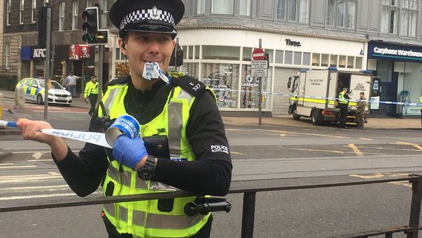 A police officer cordoning off a section of Prince's Street in Edinburgh. - Sputnik International