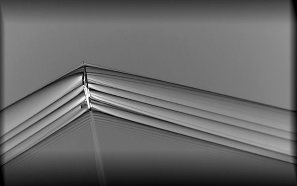 When aircraft fly faster than the speed of sound, shockwaves travel away from the vehicle, and are heard on the ground as a sonic boom. NASA researchers use this imagery to study these shockwaves as part of the effort to make sonic booms quieter, which may open the future to possible supersonic flight over land. The updated camera system used in the AirBOS flight series enabled the supersonic T-38 to be photographed from much closer, approximately 2,000 feet away, resulting in a much clearer image compared to previous flight series. - Sputnik International