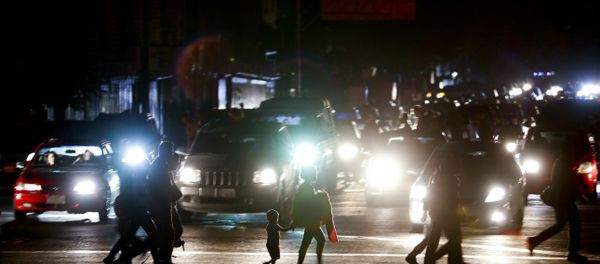Residents cross a street in the dark after a power outage in Caracas, Venezuela, Thursday, March 7, 2019. A power outage left much of Venezuela in the dark early Thursday evening in what appeared to be one of the largest blackouts yet in a country where power failures have become increasingly common. Crowds of commuters in capital city Caracas were walking home after metro service ground to a halt and traffic snarled as cars struggled to navigate intersections where stoplights were out. Residents cross a street in the dark after a power outage in Caracas, Venezuela, Thursday, March 7, 2019. A power outage left much of Venezuela in the dark early Thursday evening in what appeared to be one of the largest blackouts yet in a country where power failures have become increasingly common. Crowds of commuters in capital city Caracas were walking home after metro service ground to a halt and traffic snarled as cars struggled to navigate intersections where stoplights were out. - Sputnik International