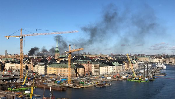 Smoke from a bus explosion and fire is seen in Tegelbacken in central Stockholm Smoke from a bus explosion and fire is seen in Tegelbacken in central Stockholm - Sputnik International